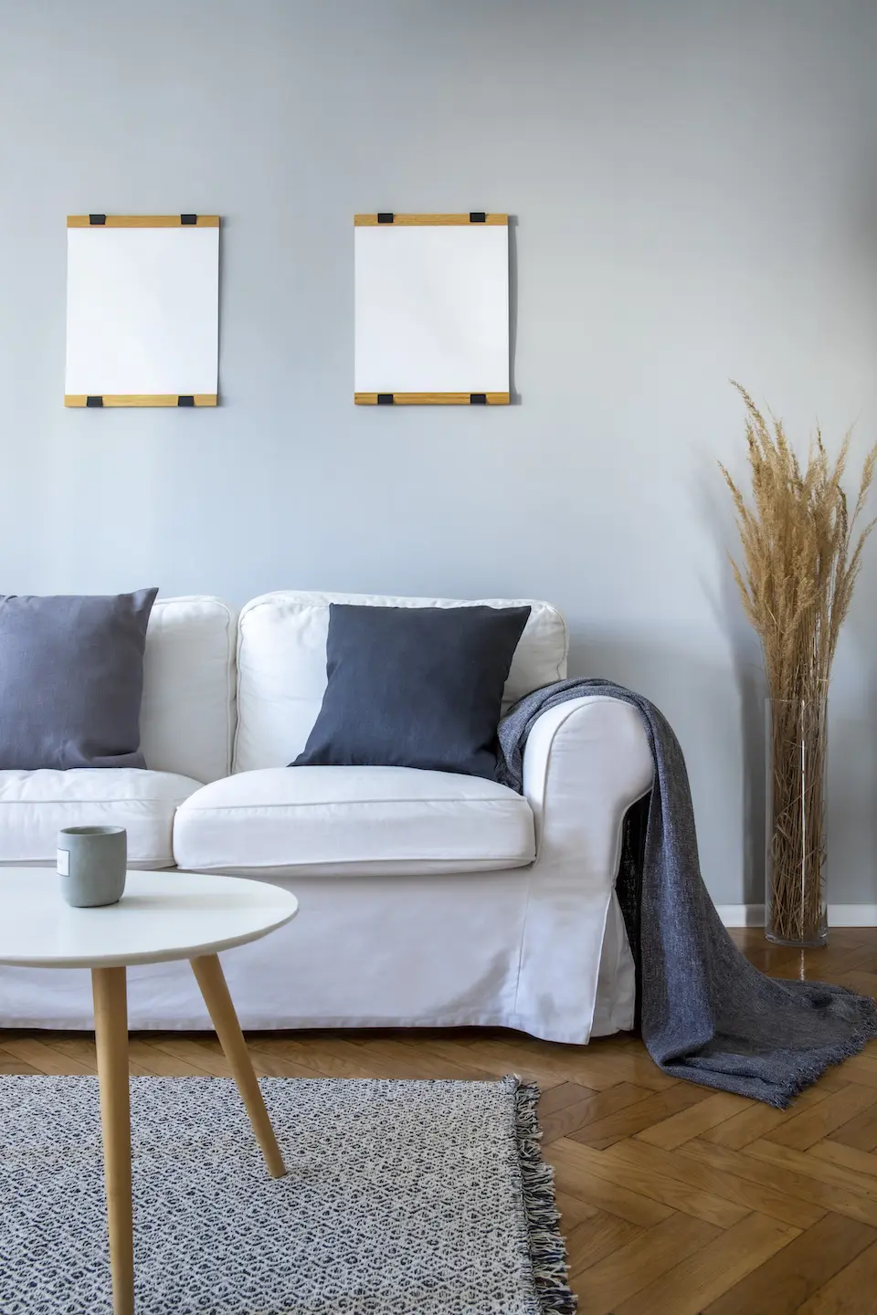 Grey pillows and blanket on white sofa in small li 2021 04 03 14 15 14 utc